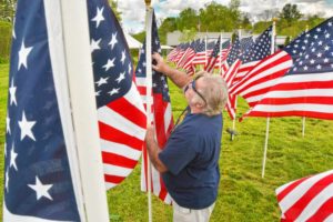 Don Rippetoe, of Southampton, places a flag while constructing the first annual Stars and Stripes Field of Honor, Monday, May 20, 2019 at Northampton Elks Lodge 997.