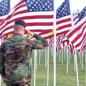 Active Military soldier saluting Healing Field flags.