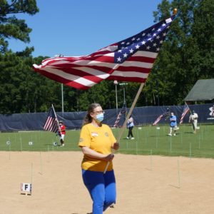 Laurie Lund carries Old Glory