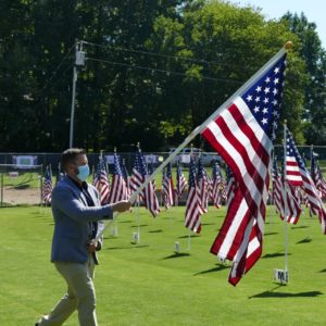 Pastor carries the flag