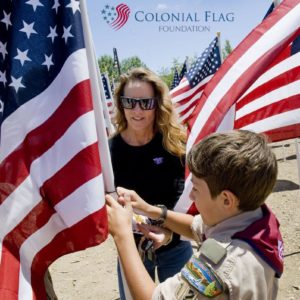 Honor scout Nic Gaita of Laguna Niguel, right, with the Order of the Arrow helps Holly Carlson-Schooley of San Juan Capistrano place a flag in honor of Navy Seal JR Schooley. The Field of Honor was organized by Homefront America for Memorial Day.

 ///ADDITIONAL INFO: 0526.sjc.honor - 5/21/16 - Photo by PAUL RODRIGUEZ - Honor scouts from the Order of the Arrow help place 300 large flags for a Field of Honor at Los Rios Park in San Juan Capistrano. The event is organized by Homefront America which will conduct a Memorial Day ceremony at the park.