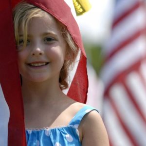 100515-A-6312K-181 FAYETTEVILLE, N.C. óAutumn Rodgers, 6, is blanketed by the American flag placed in honor of her deceased father during the opening ceremony at this yearís Glory Days Field of Honor outside the grounds of the Airborne and Special Operations Museum Saturday in Fayetteville. ìThis is my daddyís flag,î Autumn, 6, said as she wrapped the flag around her, hugging it as if it was her father. (U.S. Army Photo by Cpl. Jessica M. Kuhn, 49th Public Affairs Detachment (Airborne))