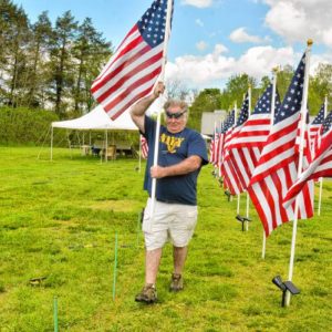 Don Rippetoe, of Southampton, carries a flag to its place while constructing the first annual Stars and Stripes Field of Honor, Monday, May 20, 2019 at Northampton Elks Lodge 997. Bruce Zeitler, left, of Florence, helped him. Both are veterans and members of the lodge.