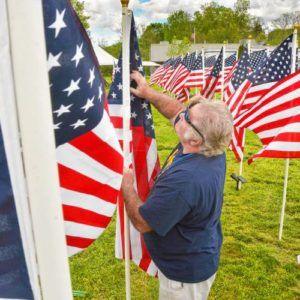 Don Rippetoe, of Southampton, places a flag while constructing the first annual Stars and Stripes Field of Honor, Monday, May 20, 2019 at Northampton Elks Lodge 997.