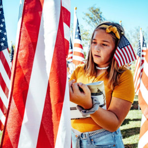 Aubree Barba, 10, a 5th grade student from Lisa J. Mails Elementary School, writes down information about a Medal of Honor recipient during a field trip to the Field of Honor at Town Square Park in Murrieta on Tuesday, Nov. 12, 2019. (Photo by Watchara Phomicinda, The Press-Enterprise/SCNG)