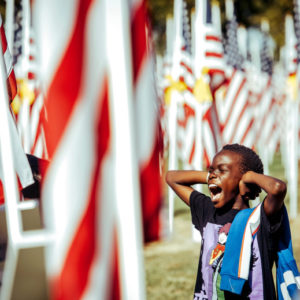 Noah Paul, 10, a 5th grade student from Lisa J. Mails Elementary School, playfully covers his ears during a field trip to the Field of Honor at Town Square Park in Murrieta on Tuesday, Nov. 12, 2019. (Photo by Watchara Phomicinda, The Press-Enterprise/SCNG)