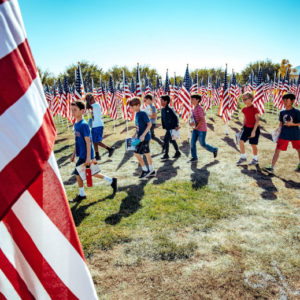 Students walk through rows of American Flags during a field trip Field of Honor at Town Square Park in Murrieta on Tuesday, Nov. 12, 2019. (Photo by Watchara Phomicinda, The Press-Enterprise/SCNG)