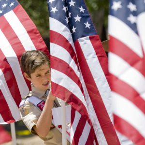 Edward Timmerman, an honor scout with the Order of the Arrow helps place one of 300 flags in Los Rios Park in San Juan Capistrano to form a Field of Honor. The event was organized by Homefront America which will host a Memorial Day ceremony at the park.

 ///ADDITIONAL INFO: 0526.sjc.honor - 5/21/16 - Photo by PAUL RODRIGUEZ - Honor scouts from the Order of the Arrow help place 300 large flags for a Field of Honor at Los Rios Park in San Juan Capistrano. The event is organized by Homefront America which will conduct a Memorial Day ceremony at the park.