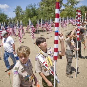 Jack McHenry, left, and Nathan Burger, center, place one of 300 flags in Los Rios Park in San Juan Capistrano. The Field of Honor will be part of a Memorial Day ceremony sponsored by Homefront America.

 ///ADDITIONAL INFO: 0526.sjc.honor - 5/21/16 - Photo by PAUL RODRIGUEZ - Honor scouts from the Order of the Arrow help place 300 large flags for a Field of Honor at Los Rios Park in San Juan Capistrano. The event is organized by Homefront America which will conduct a Memorial Day ceremony at the park.