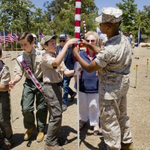 Nic Gaita, left, Edward Timmerman, second from left, and John Gaita, third from left, get a hand from Marines from Camp Pendleton as they place a flag in Los Rios Park for Bob and Peg Nietzel, center, of San Juan Capistrano. The Field of Honor was organized by Homefront America for Memorial Day.

 ///ADDITIONAL INFO: 0526.sjc.honor - 5/21/16 - Photo by PAUL RODRIGUEZ - Honor scouts from the Order of the Arrow help place 300 large flags for a Field of Honor at Los Rios Park in San Juan Capistrano. The event is organized by Homefront America which will conduct a Memorial Day ceremony at the park.