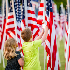 siblings with a flag