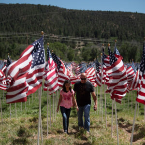 Richard Vialpando, of Questa, and his 10-year-old daughter, Cieara Vialpando, pay their respects Monday (May 28) at Taos CountyÕs 13th Annual Field of Honor flag display in Questa.